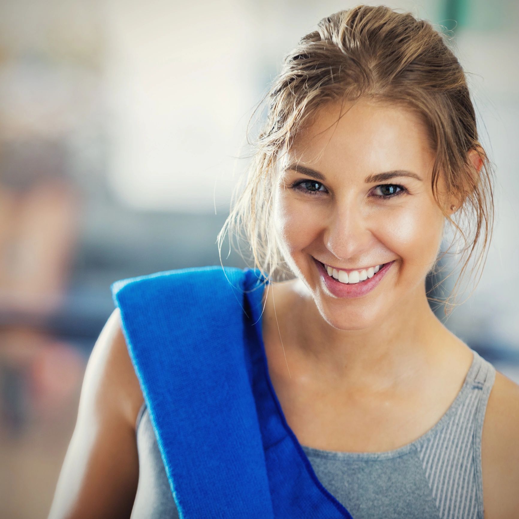 Portrait of a confident gym client smiling after a workout